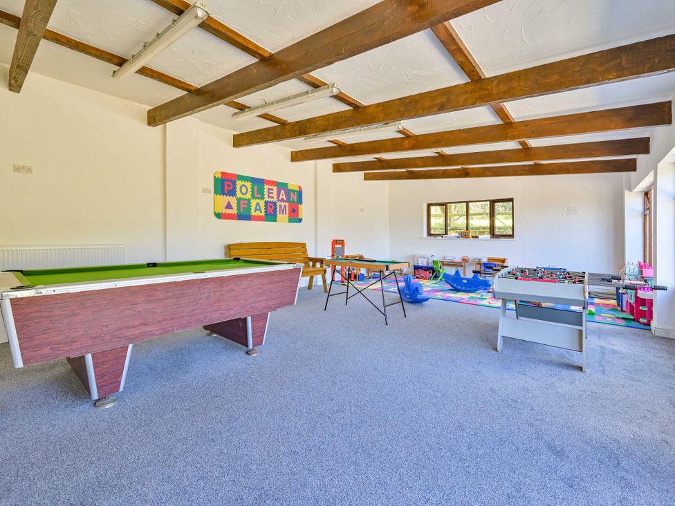 A games room with a pool table and foosball table at The Old Farm House near Pelynt