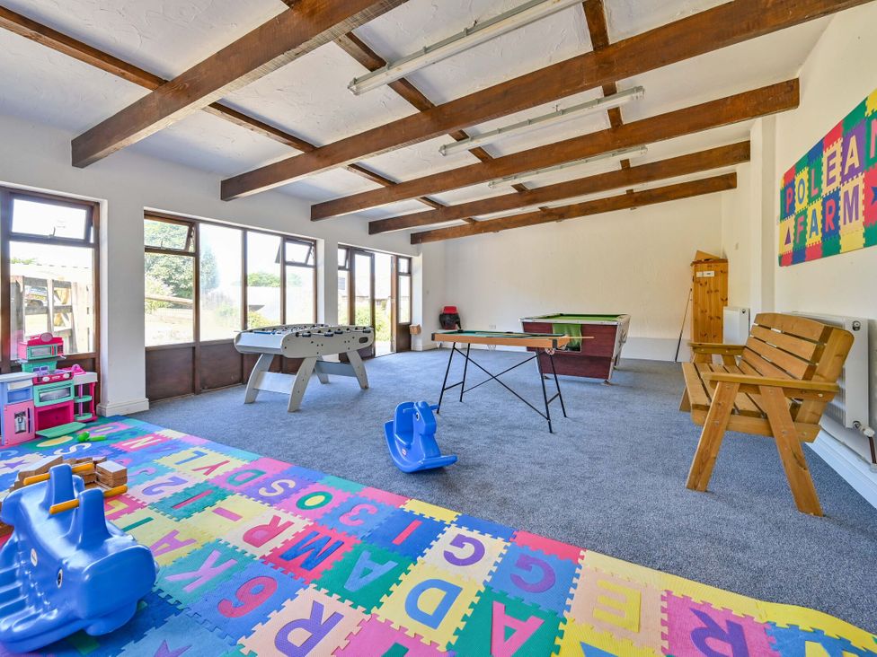 A playroom with a foosball table and a pool table at The Old Farm House near Pelynt