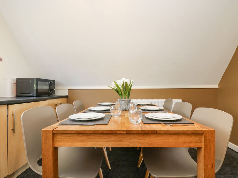 A dining room with a table and chairs at Valley Lodge 61 Callington
