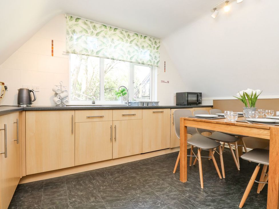 A kitchen with a table and chairs at Valley Lodge 61 Callington