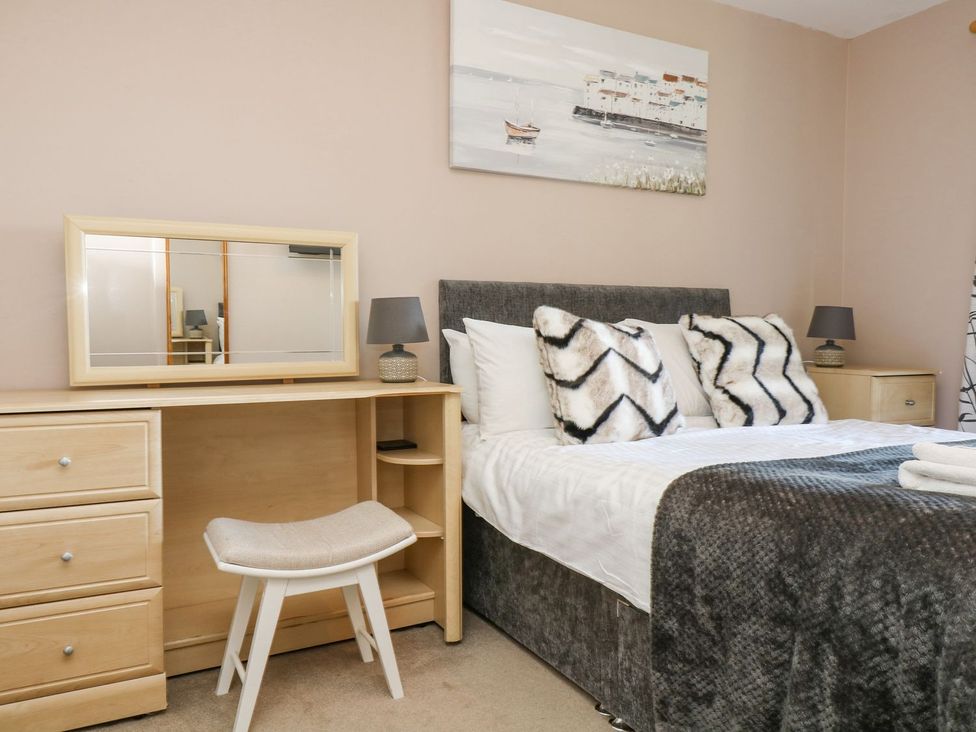 A bedroom with a bed and a mirror at Valley Lodge 61 Callington
