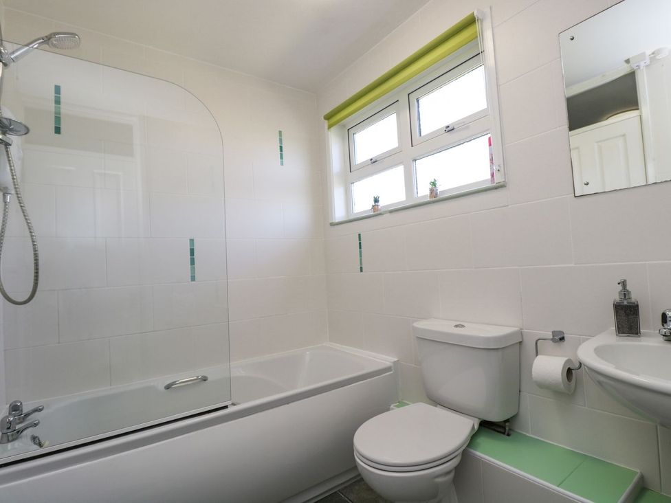 A bathroom with a bathtub and shower at Valley Lodge 61 in Callington