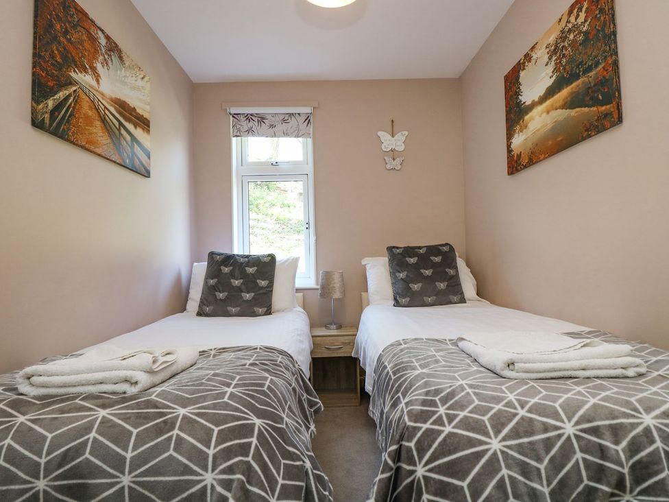 A bedroom with two beds and a window at Valley Lodge 61 in Callington