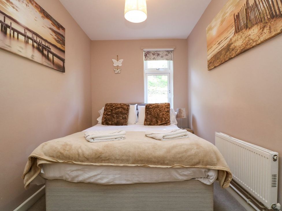 A bedroom with a bed and window at Valley Lodge 61 Callington