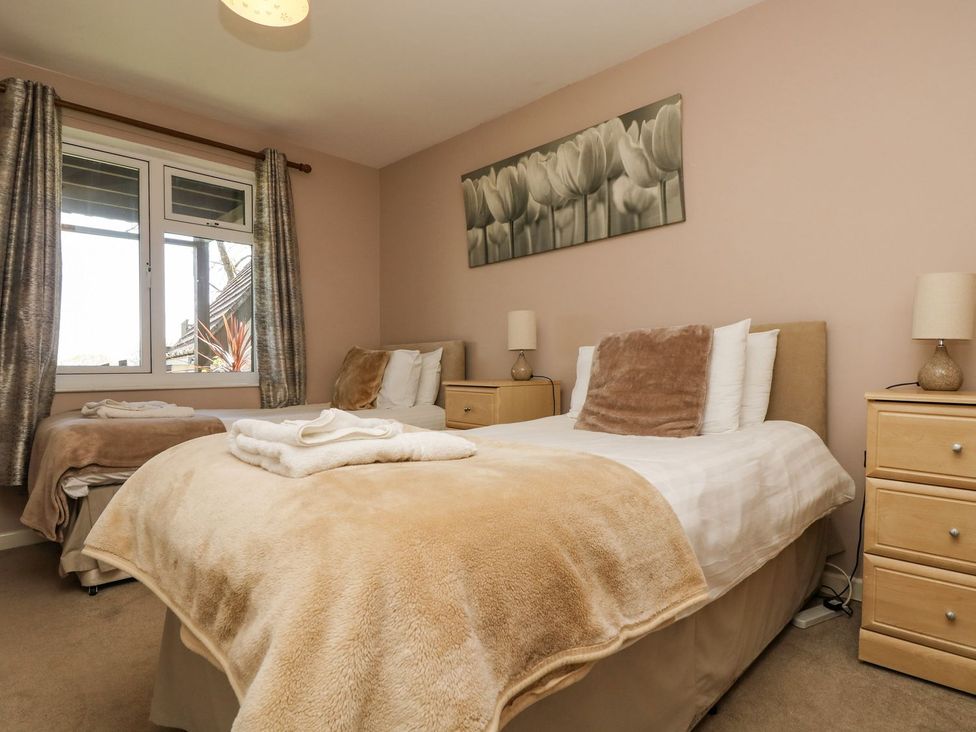 A bedroom with two beds and nightstands at Valley Lodge 61, Callington