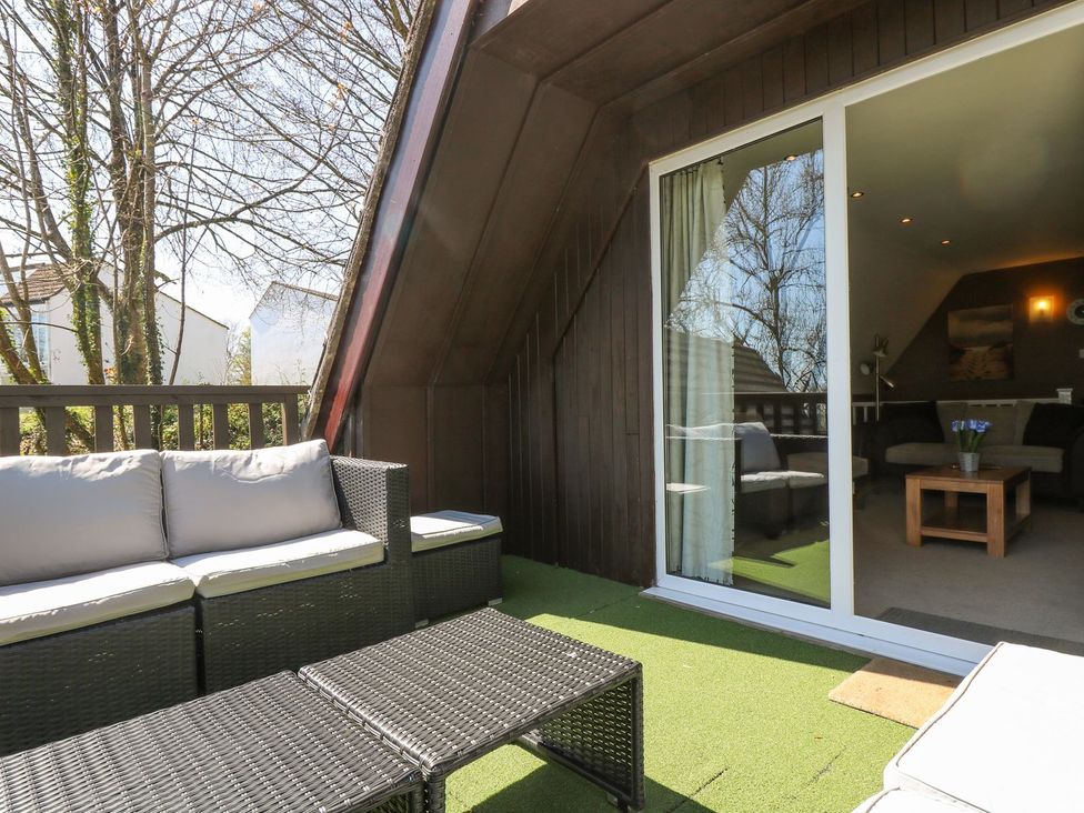 An outdoor seating area with a sofa and table at Valley Lodge 61 in Callington