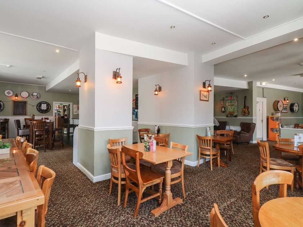 A dining area with tables and chairs at Valley Lodge 61 in Callington