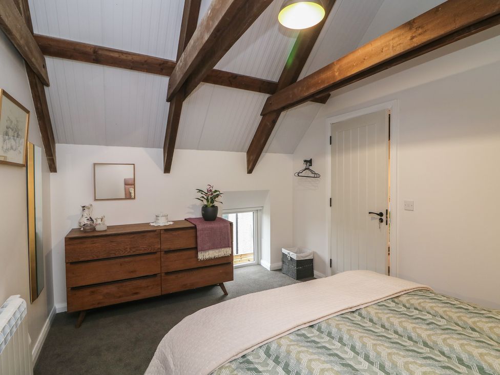 A bedroom with a bed and dresser at The Loft in Glenmore, County Kilkenny