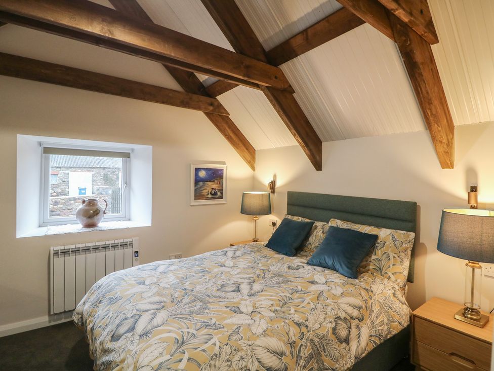 A bedroom with a bed and lamps at The Loft in Glenmore, County Kilkenny
