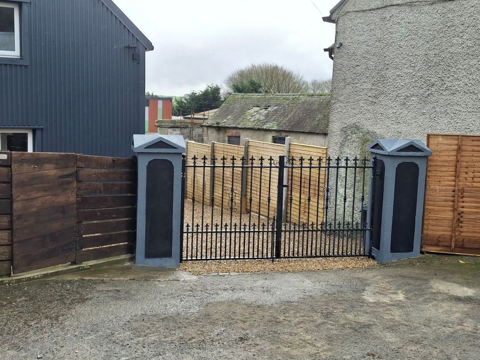 A gated entrance with wooden and metal fences at The Loft in Glenmore, County Kilkenny