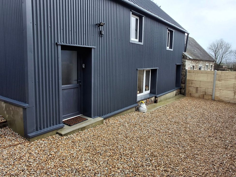 An exterior view of a gray metal building with a door and gravel area at The Loft in Glenmore, County Kilkenny