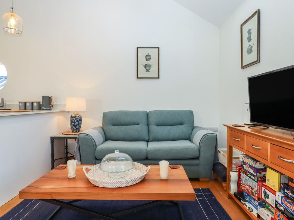 A living room with a sofa and coffee table at Hilldown Granary near Bow