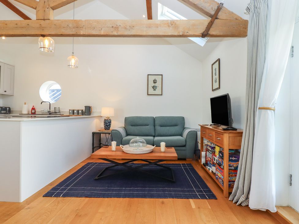 A living room with a sofa and coffee table at Hilldown Granary near Bow