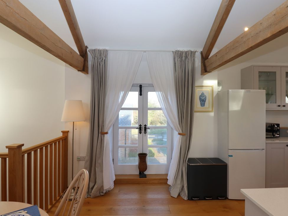 A kitchen with a window and fridge at Hilldown Granary near Bow
