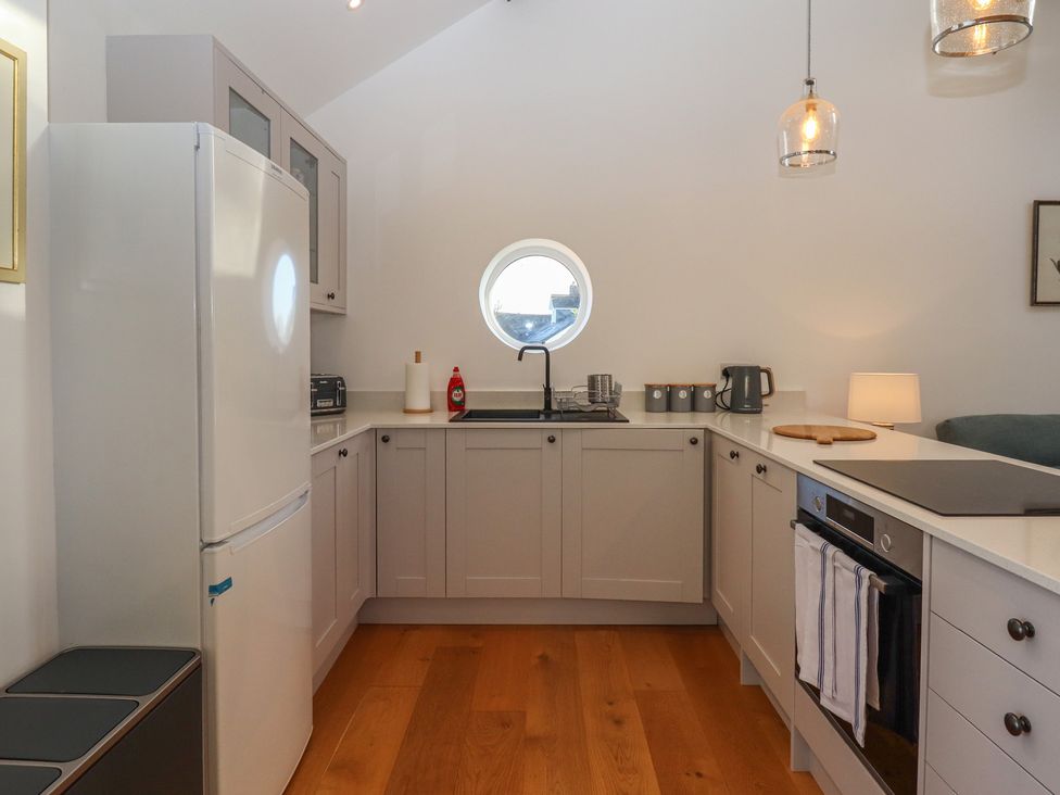 A kitchen with sink and refrigerator at Hilldown Granary near Bow