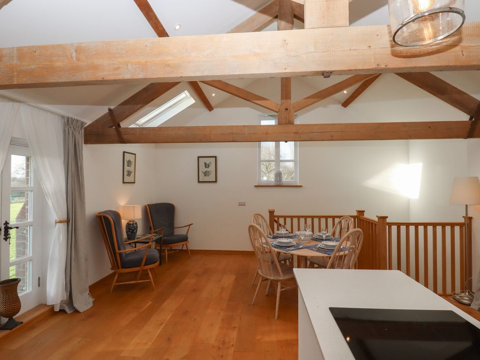 A living room with chairs and dining table at Hilldown Granary near Bow