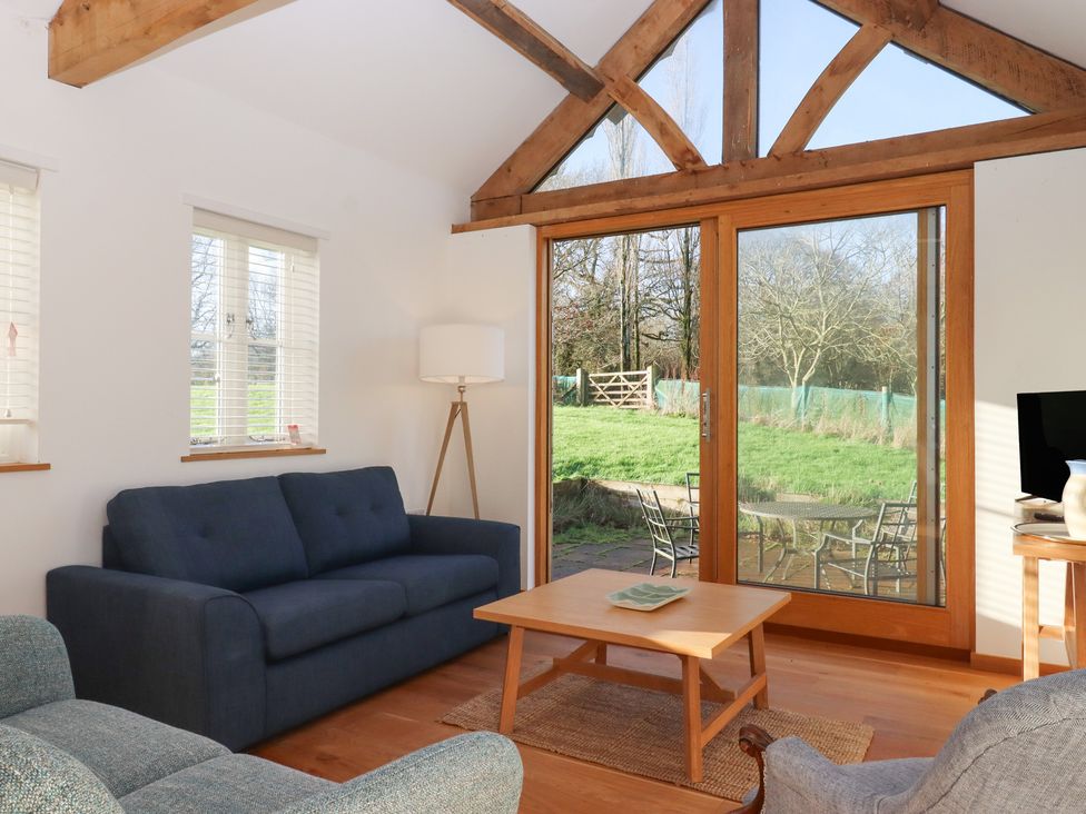 A living room with a sofa and a table at Hilldown Cott near Bow