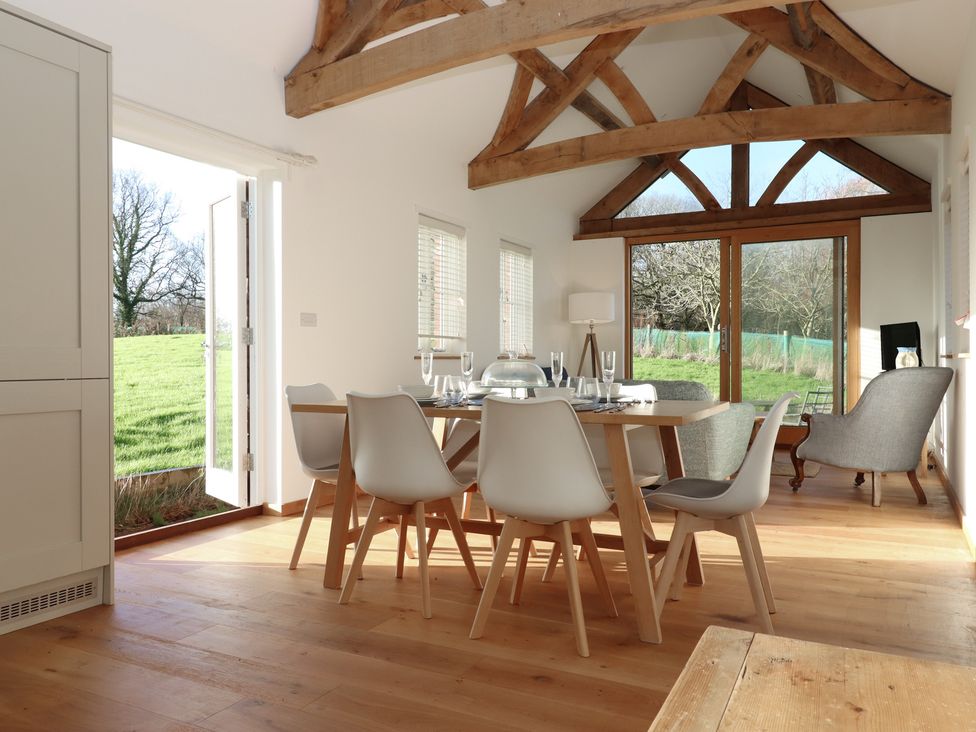 A dining room with a table and chairs at Hilldown Cott near Bow
