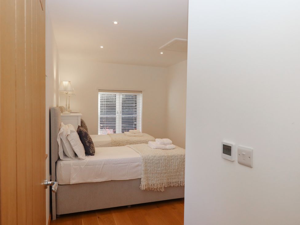 A bedroom with beds and a lamp at Hilldown Cott near Bow