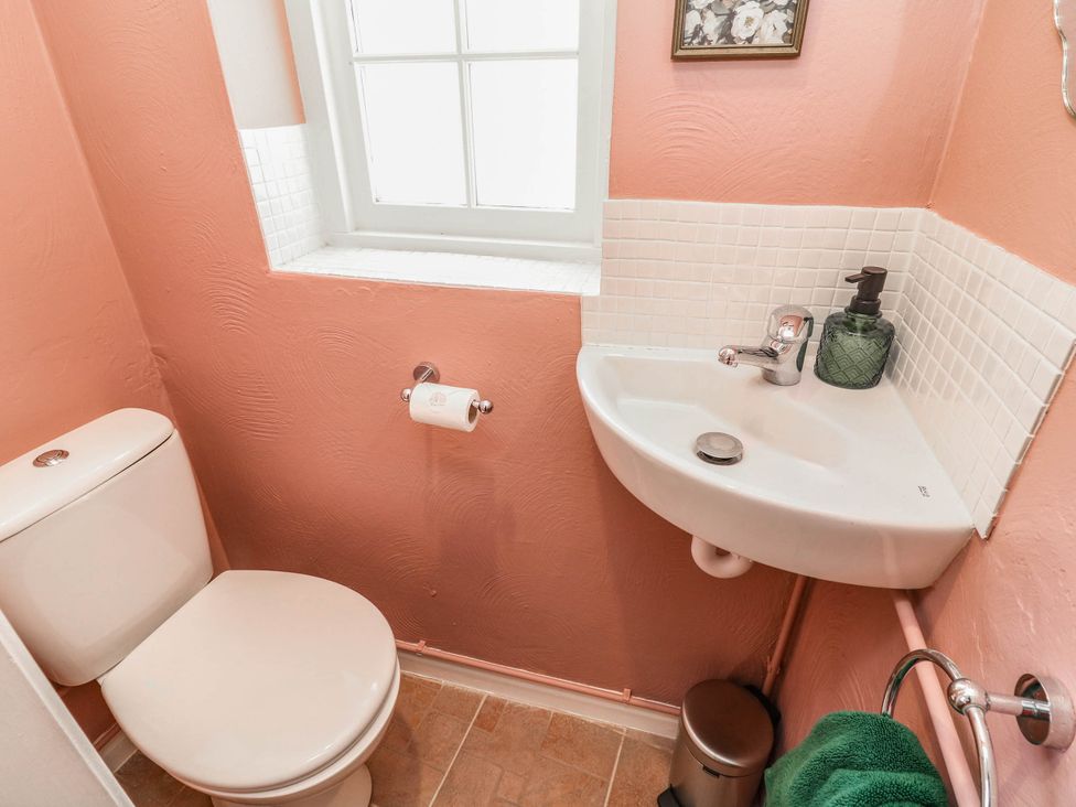 A bathroom with a toilet and sink at Freya Cottage in Metheringham