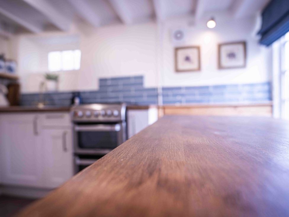 A kitchen with a countertop and oven at Freya's Cottage in Metheringham