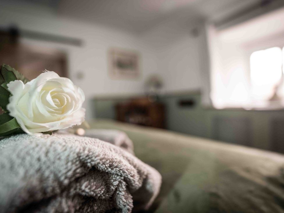 A towel with a rose on it at Freya's Cottage in Metheringham