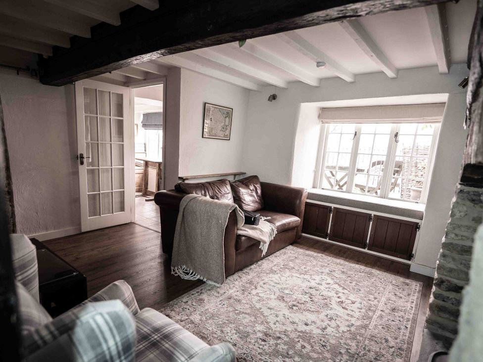 A living room with a sofa and window at Freya's Cottage Metheringham