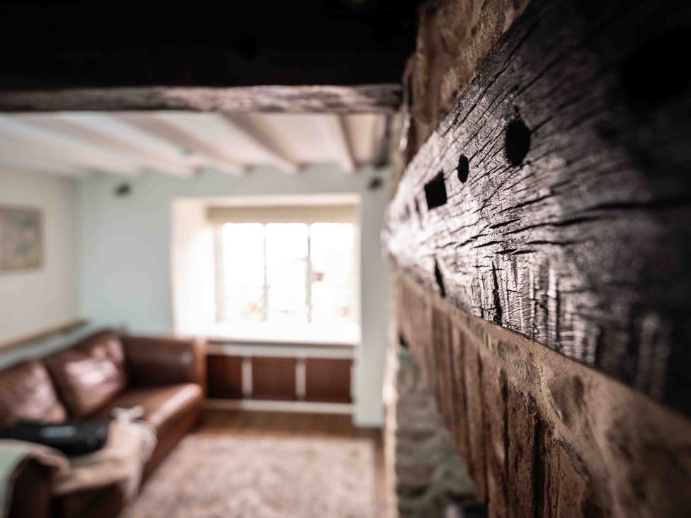 A living room with a sofa and a window at Freya's Cottage in Metheringham