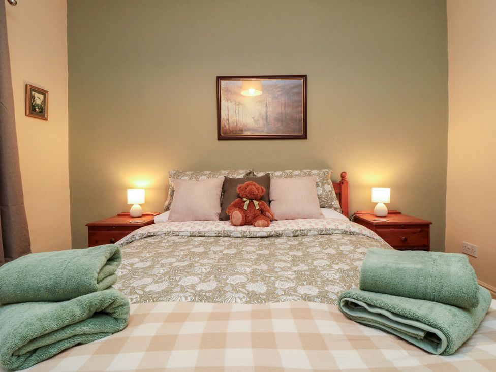 A bedroom with a bed and teddy bear at Daisy cottage in Pickering