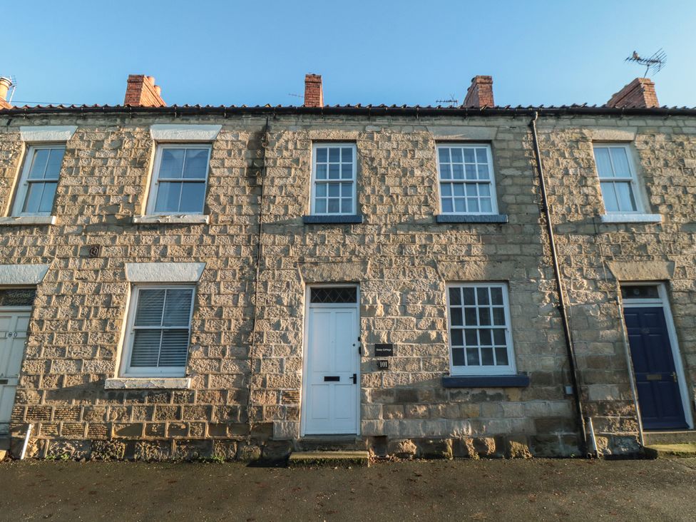 A stone house with multiple windows and a front door at Daisy cottage Pickering