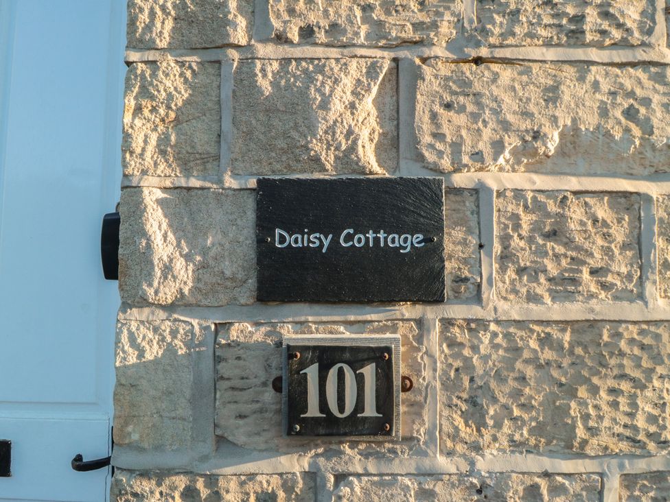 A sign indicating Daisy Cottage and the number 101 at Daisy Cottage in Pickering