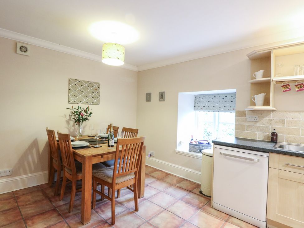 A kitchen with a dining table and chairs at The Cottage in Perth
