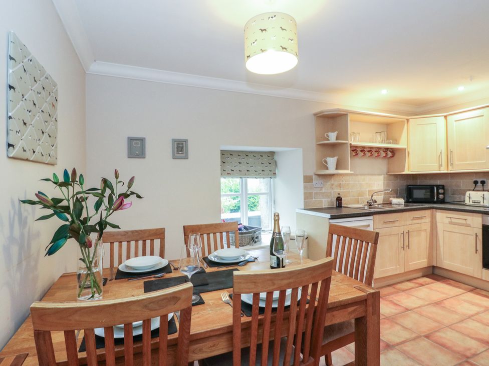 A kitchen with a table and chairs at The Cottage in Perth