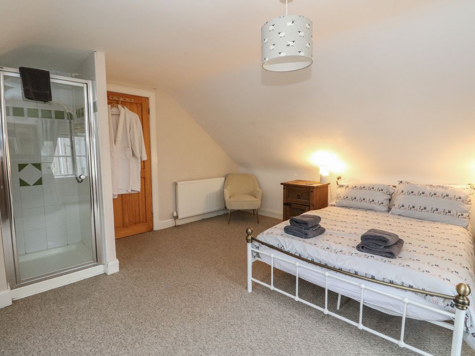 A bedroom with a bed and a shower at The Cottage in Perth