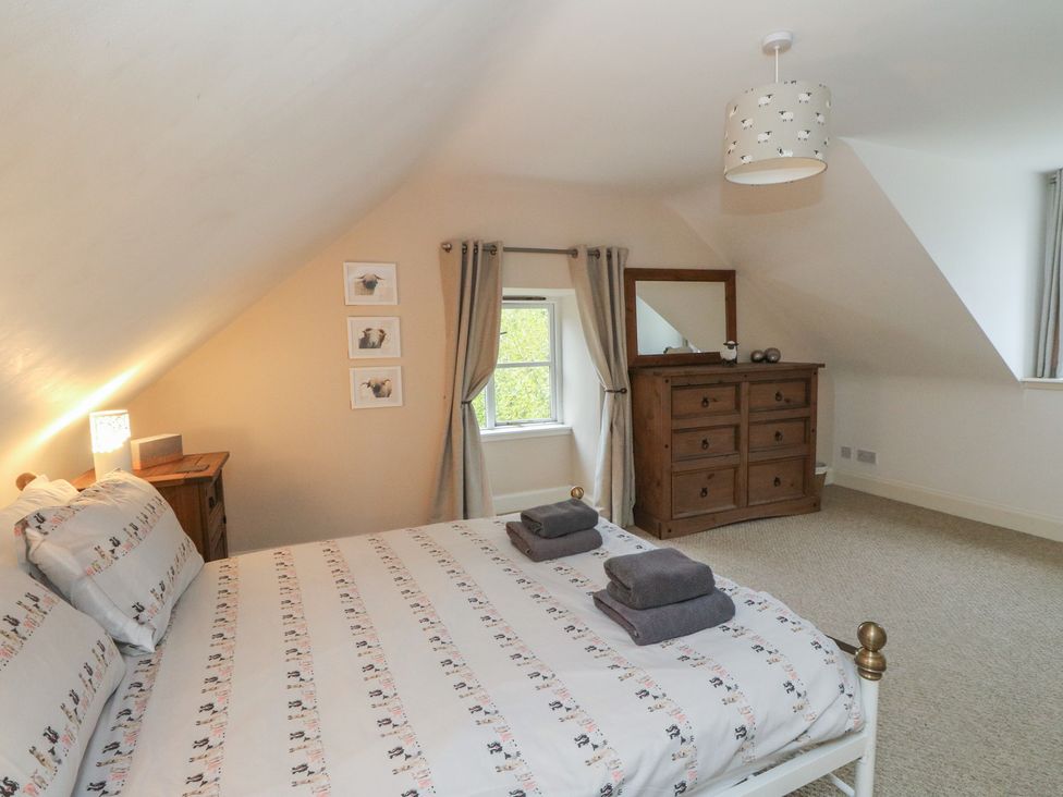 A bedroom with a bed and a dresser at The Cottage in Perth