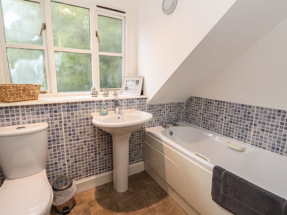 A bathroom with a toilet, sink, and bathtub at The Cottage in Perth