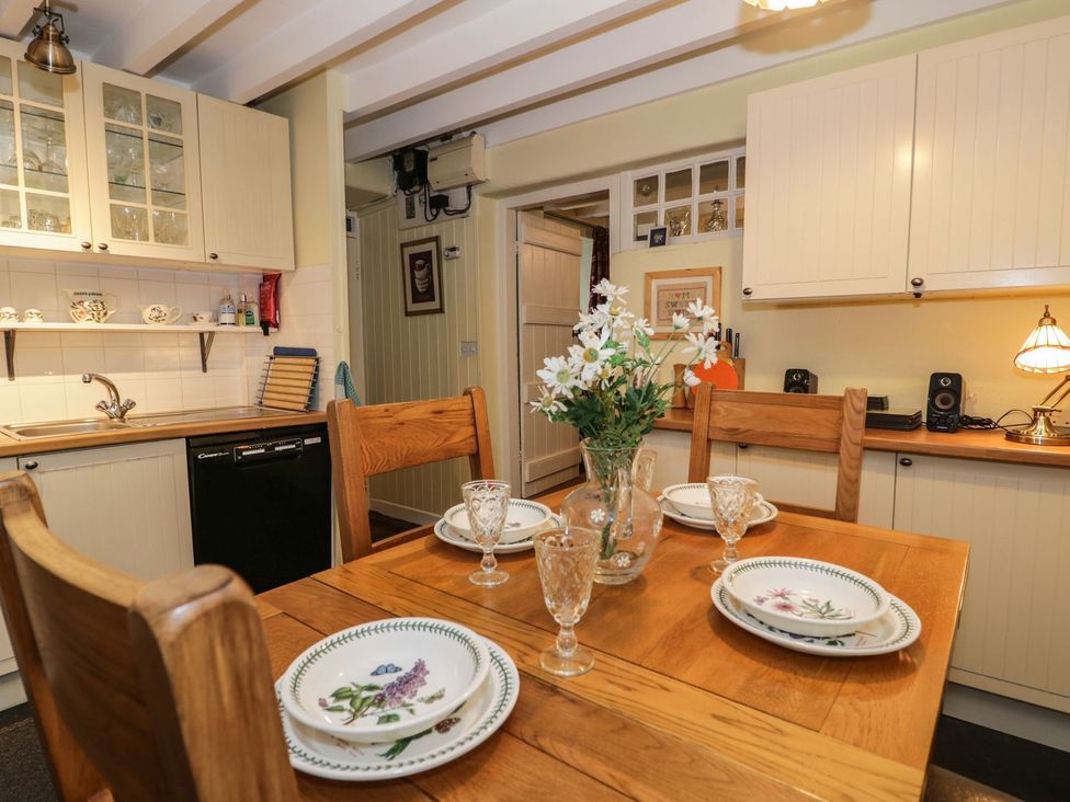 A dining room with a table set for four at Noddfa Penmachno