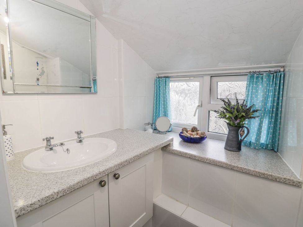A bathroom with a sink and mirror at Noddfa in Penmachno