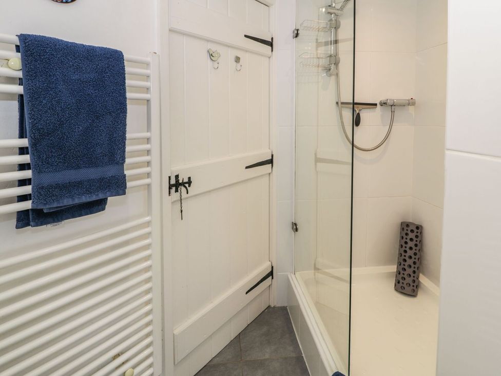 A bathroom with a shower and towel rail at Noddfa Penmachno