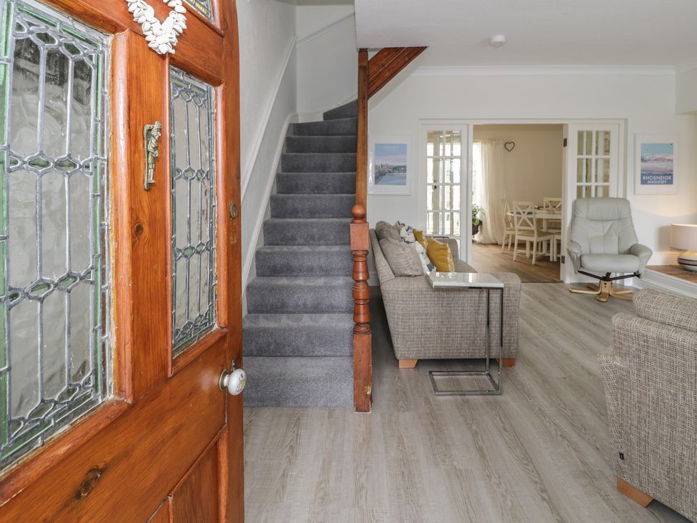 A hallway with a staircase and living area at The Hideaway in Penrhyn Bay