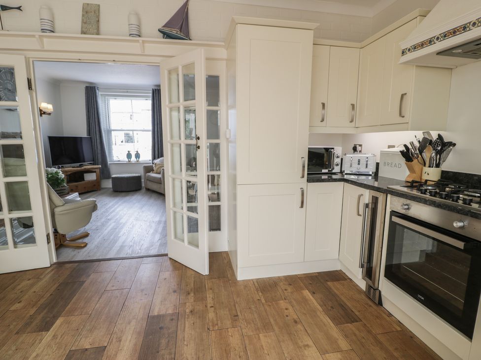 A kitchen with a stove and microwave at The Hideaway in Penrhyn Bay