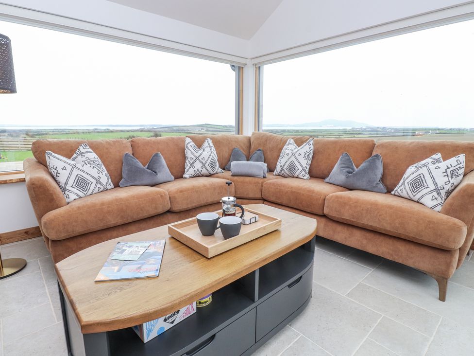 A snug with a sofa and coffee table at 2 Trem Y Mor Llanfwrog near Llanfachraeth