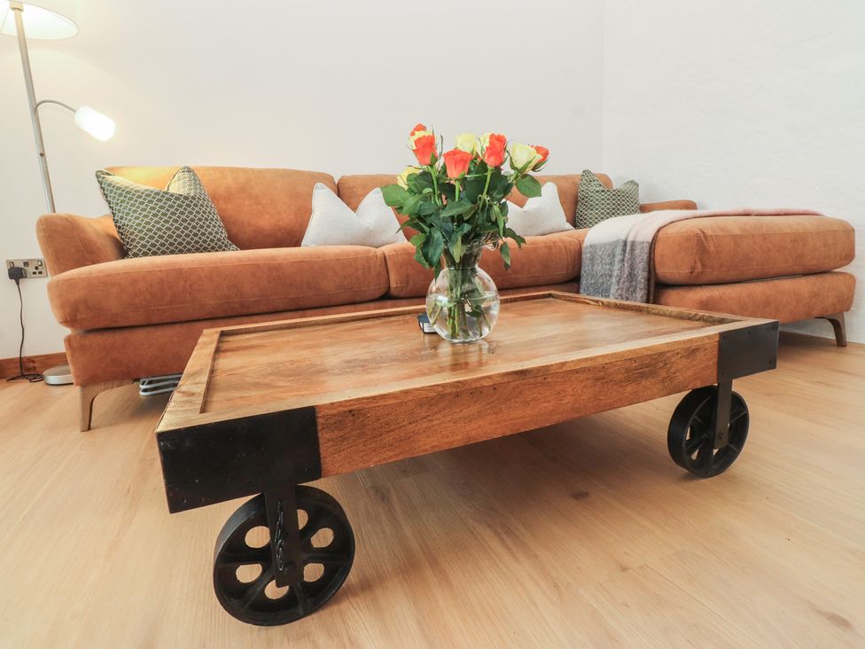 A living room with a sofa and coffee table at Hen Penmynydd, Llanfwrog near Llanfachraeth