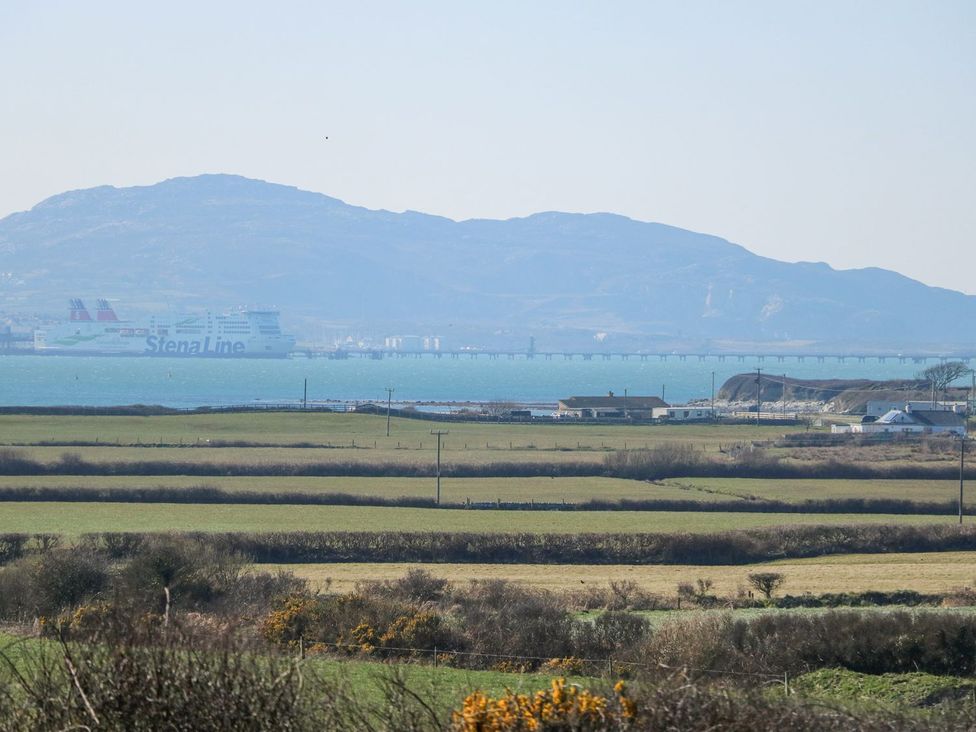 A view including a ferry and mountain at Hen Penmynydd in Llanfwrog near Llanfachraeth
