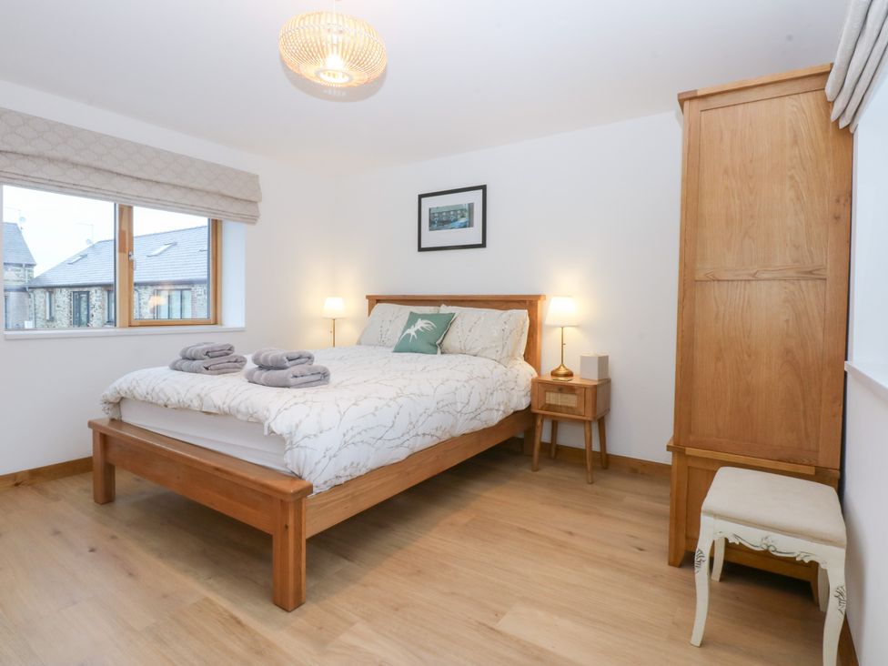 A bedroom with a bed and a bedside table at Hen Penmynydd Llanfwrog near Llanfachraeth