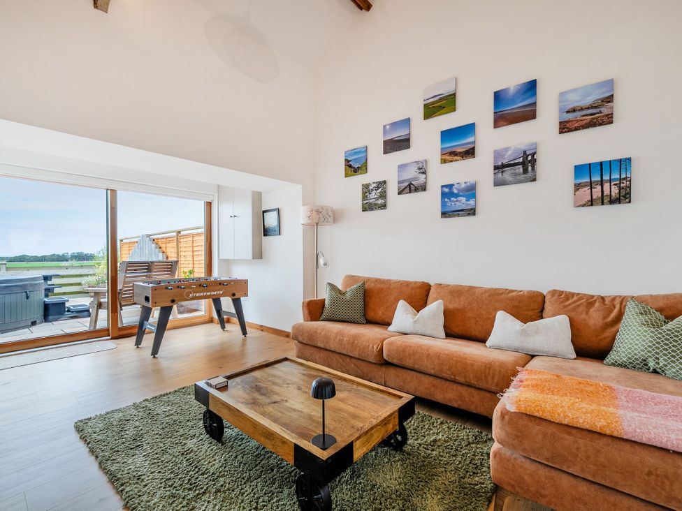 A living room with a foosball table and a sofa at Hen Penmynydd Llanfwrog near Llanfachraeth