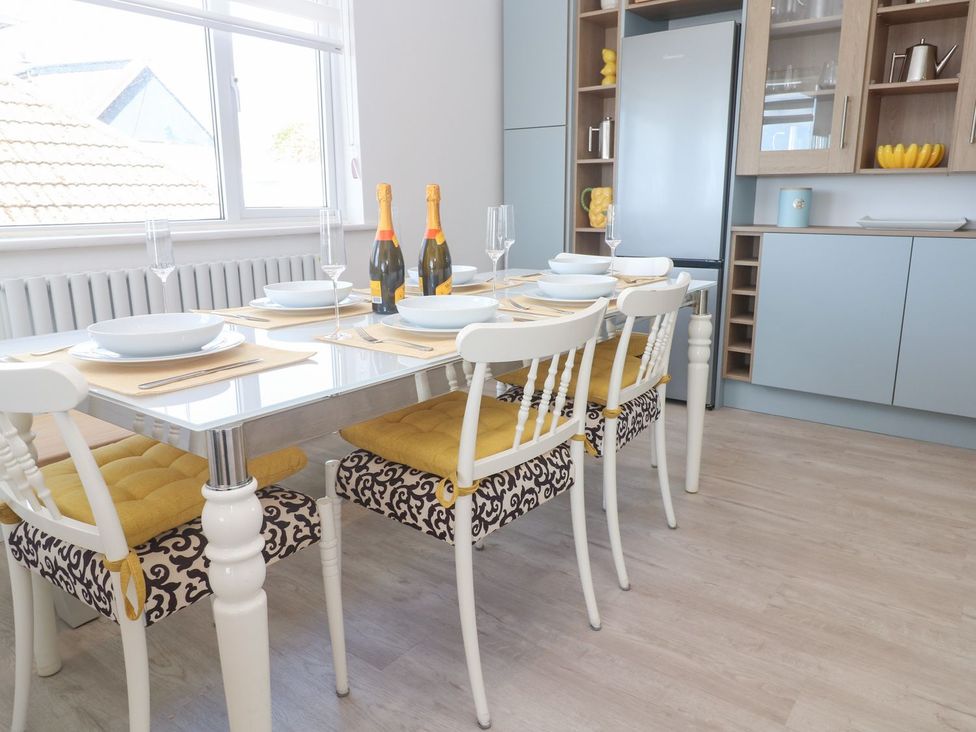 A dining room with a table set for a meal at Shearwater in Praa Sands