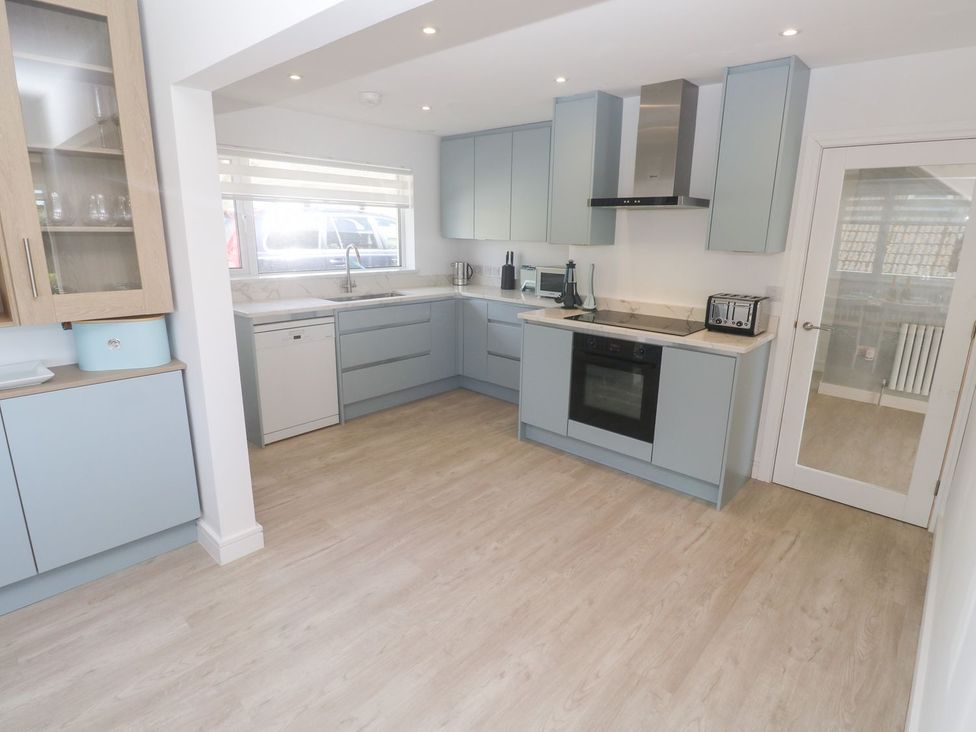 A kitchen with cabinets, sink, oven, and appliances at Shearwater in Praa Sands