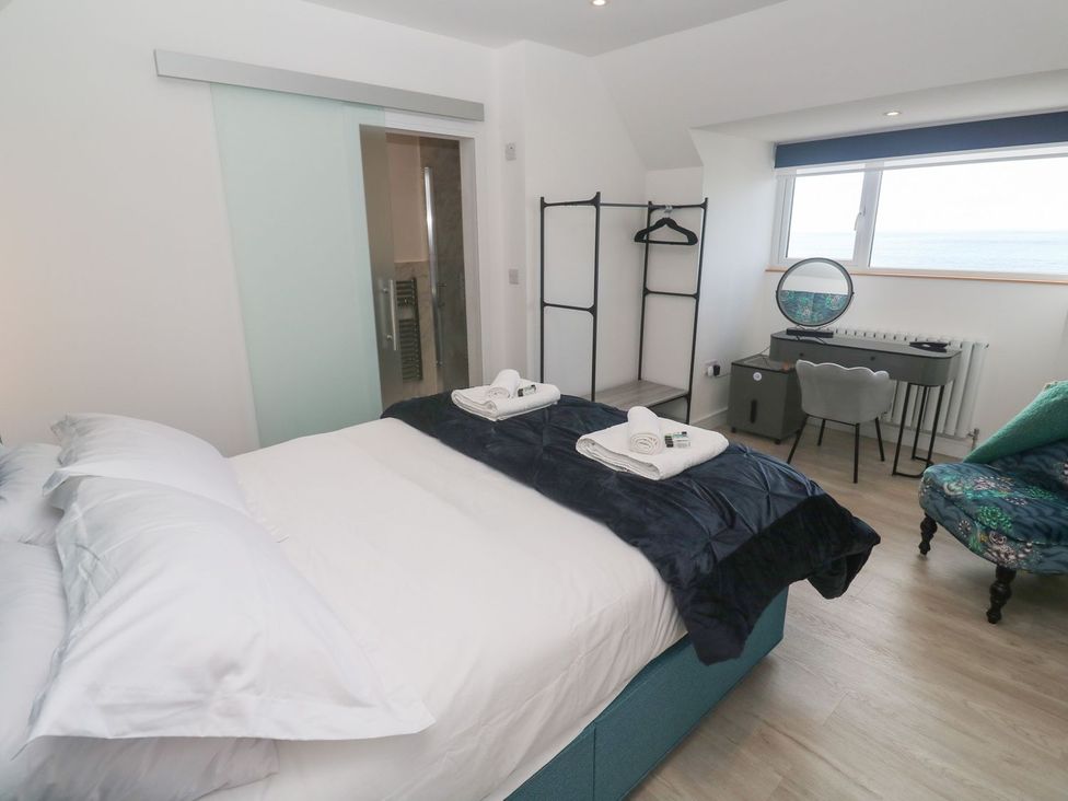 A bedroom with a bed and desk at Shearwater in Praa Sands
