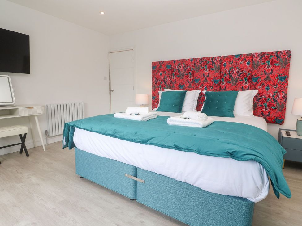 A bedroom with a bed and desk at Shearwater in Praa Sands